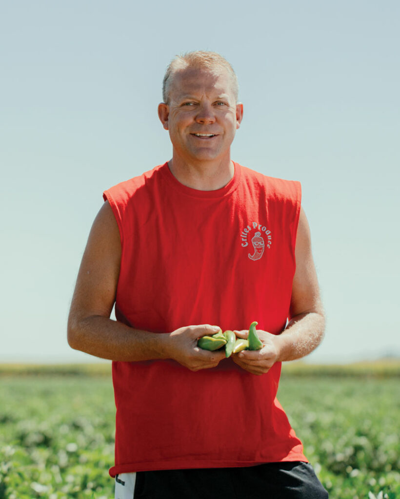 Man standing in a field in a red shirt