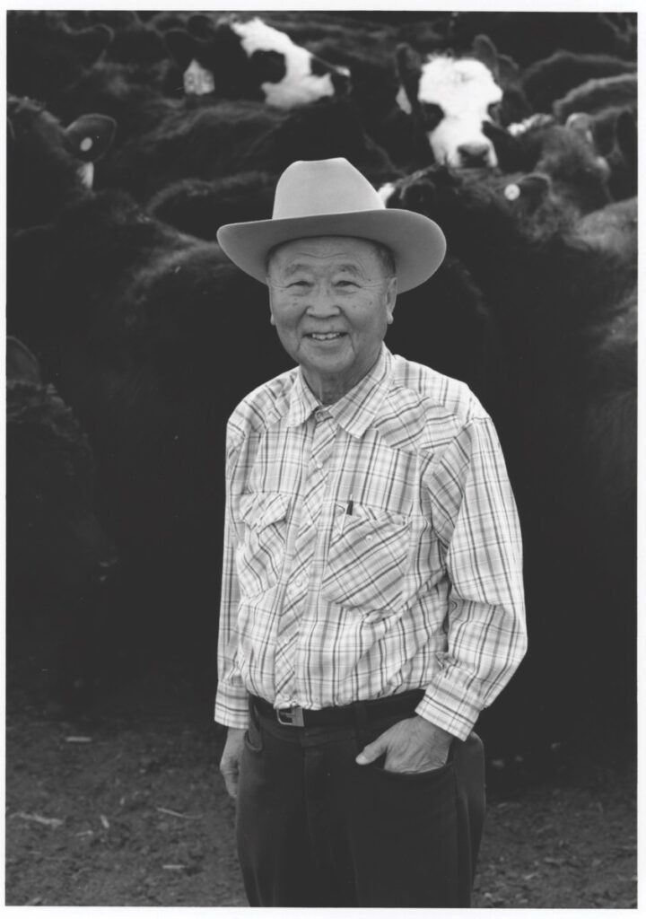 Black and white photo of a man wearing a cowboy hat.