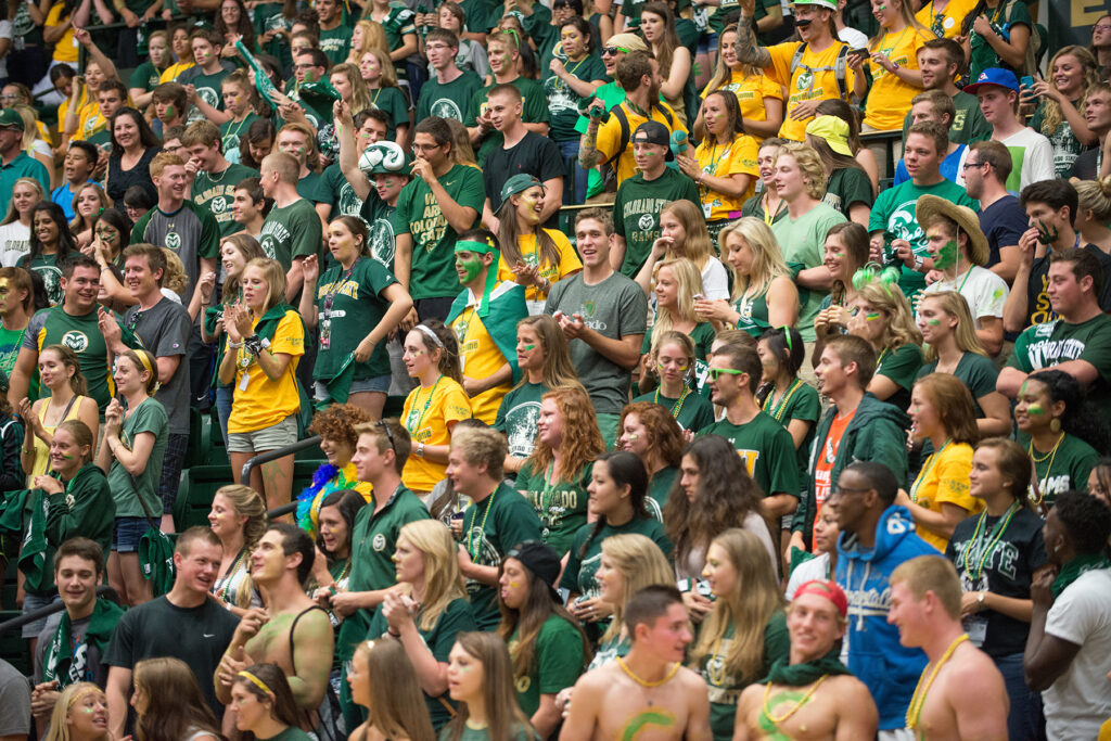A sea of students in green and gold.