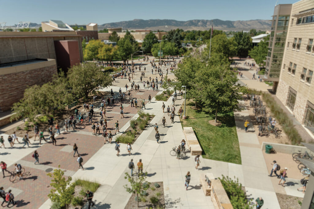 Aerial view of students walking across a college campus.