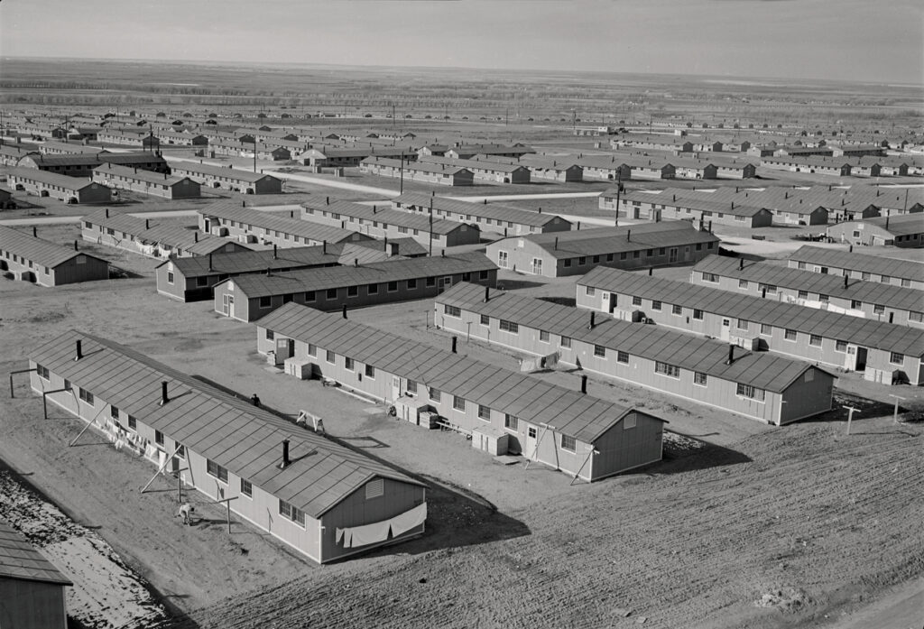 Historical photo of rows of barracks.