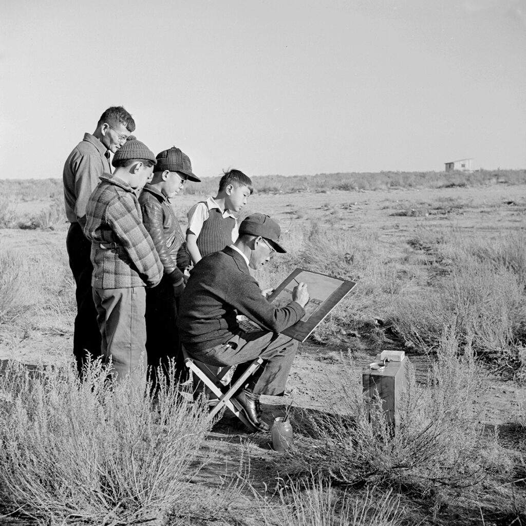 Black and white photo of a group painting.