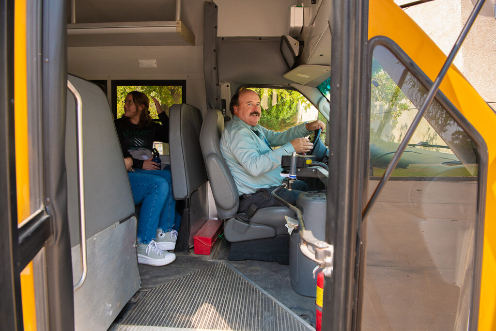 Man behind the wheel of a school bus.