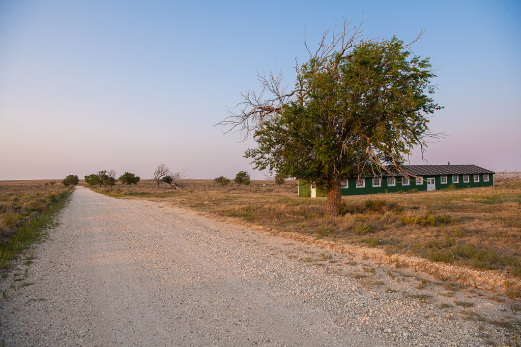 Barracks next to a gravel road.