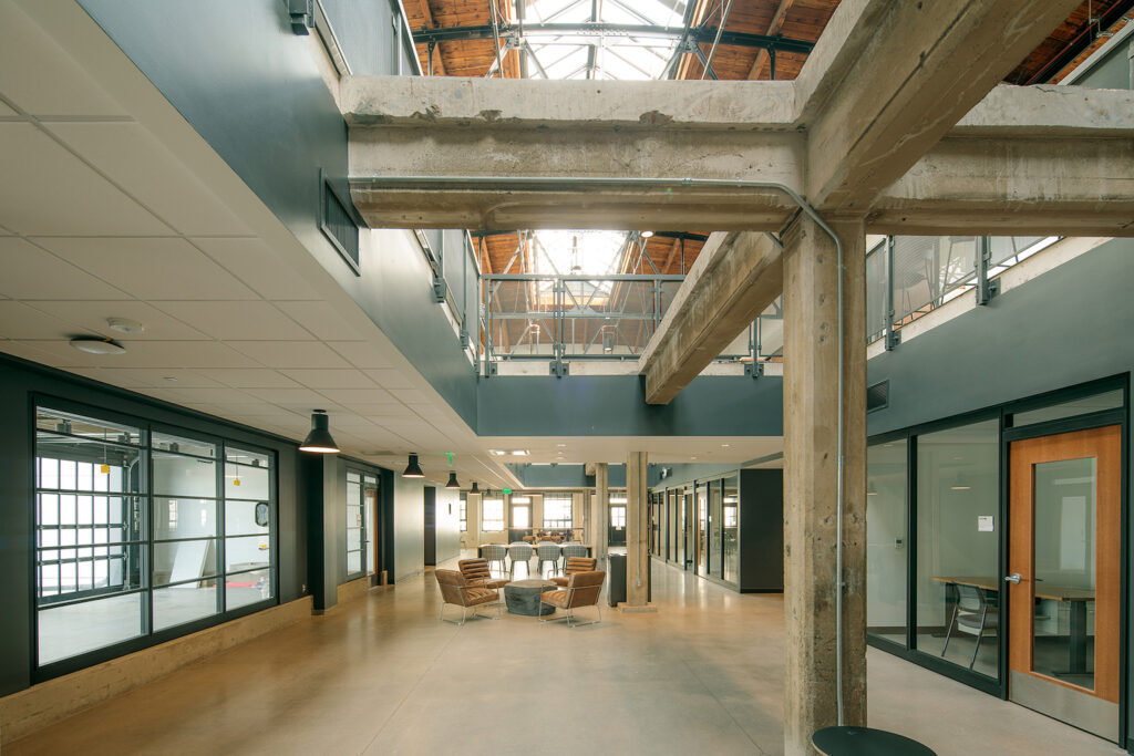 Indoor lobby space with skylights and exposed ceiling beams.