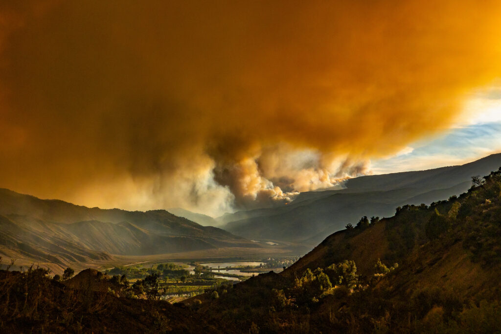 Wildfire smoke over a valley.