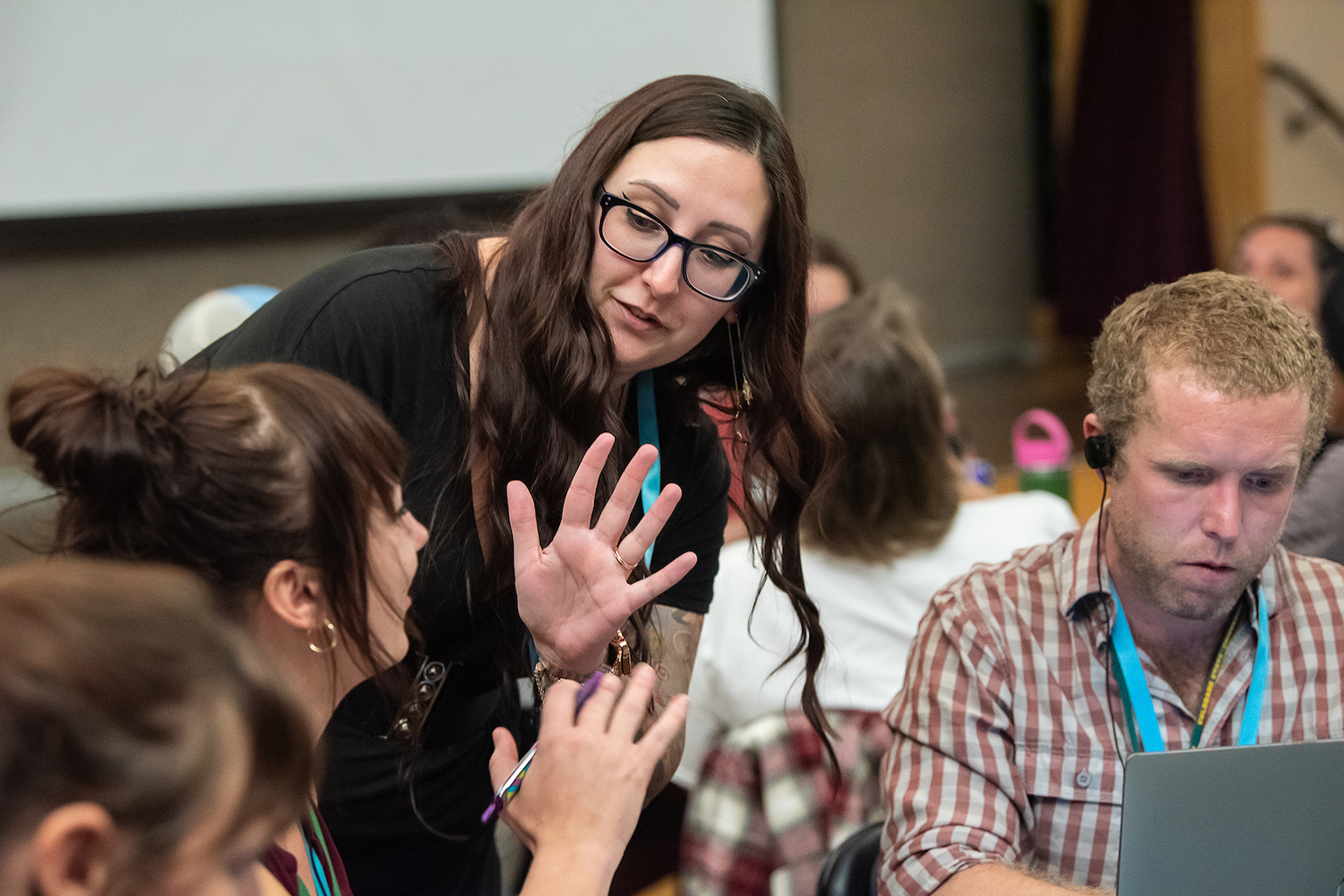 Two people converse with hand gestures.